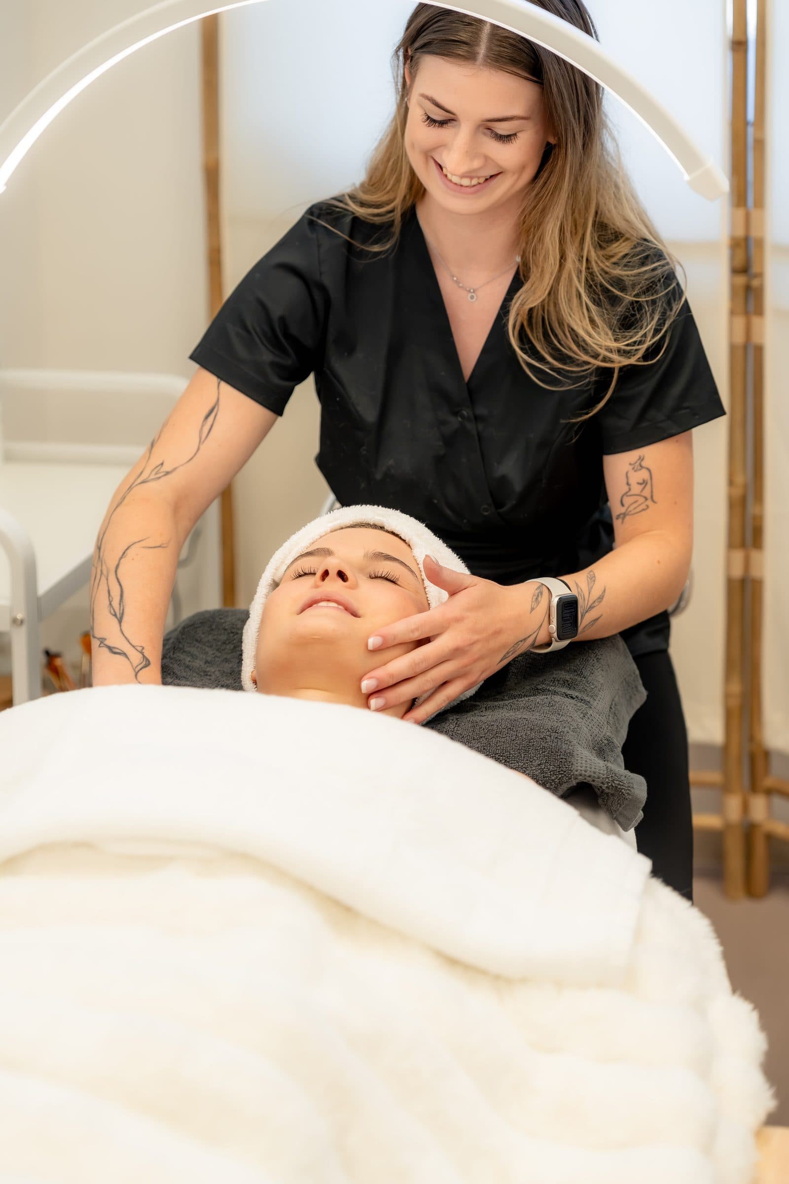 Beautician giving a facial treatment at MONA&CO